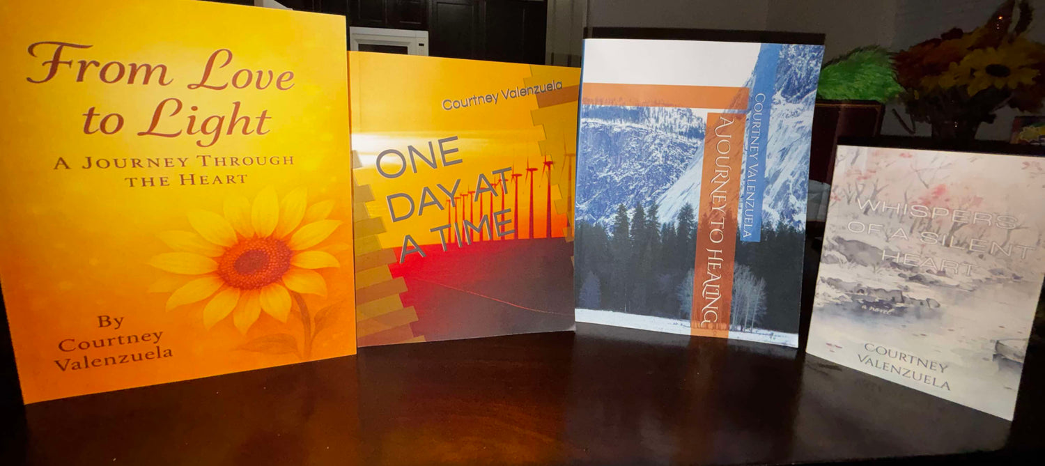 Four books by Courtney Valenzuela standing upright on a dark surface, each with distinct cover designs focused on healing and personal growth.