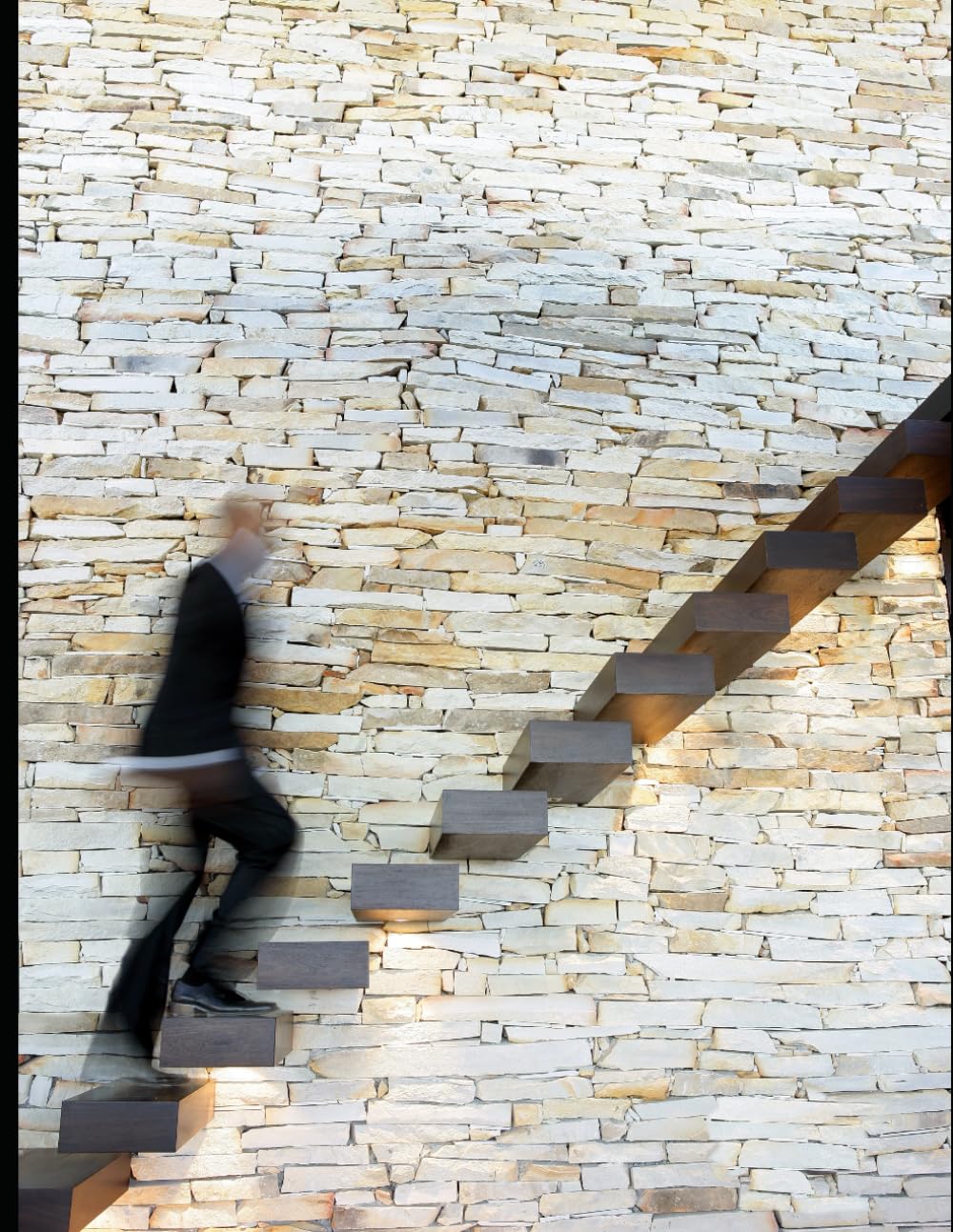 Book cover for "Step of Strength" by Courtney Valenzuela, featuring a person in a dark suit climbing a modern, floating wooden staircase mounted against a textured stone wall, captured with a motion blur effect to suggest upward movement.